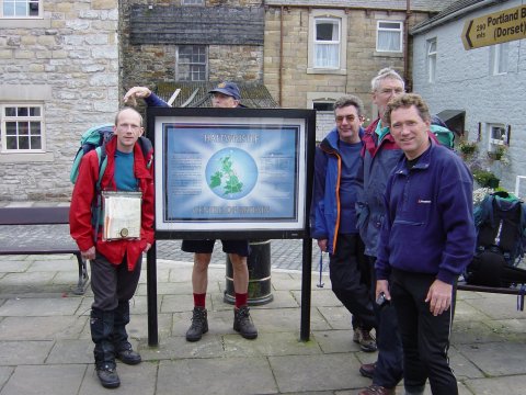 It reads:- Haltwhistle, centre of Britain!